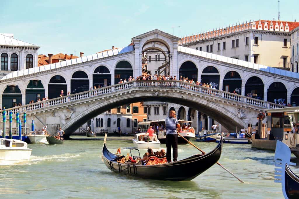 The image shows the Rialto Bridge over the Grand Canal in Venice, Italy. It is one of the most famous landmarks in Venice.