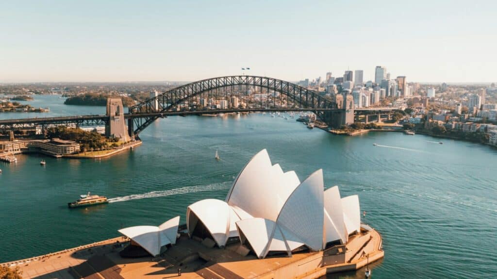 The image shows the Sydney Opera House and the Sydney Harbour Bridge in Sydney, Australia.