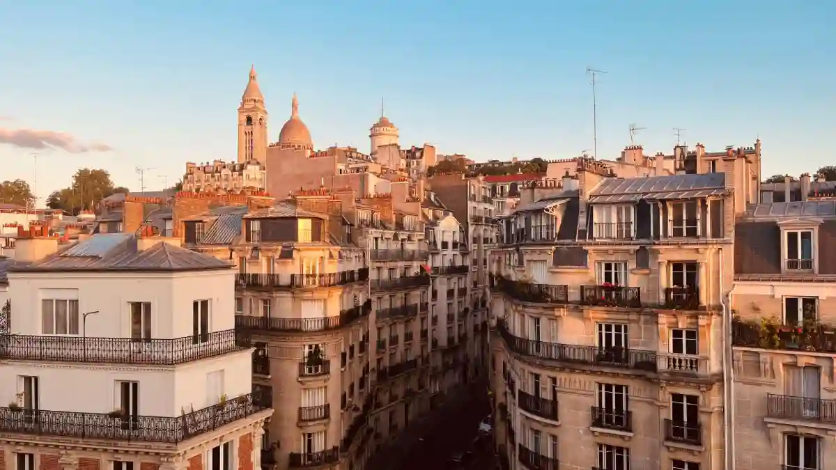 Aerial view of Parisian cityscape with modern buildings, classic rooftops, and iconic landmarks like the Eiffel Tower. Aerial view of Parisian cityscape with modern buildings, classic rooftops, and iconic landmarks like the Eiffel Tower.