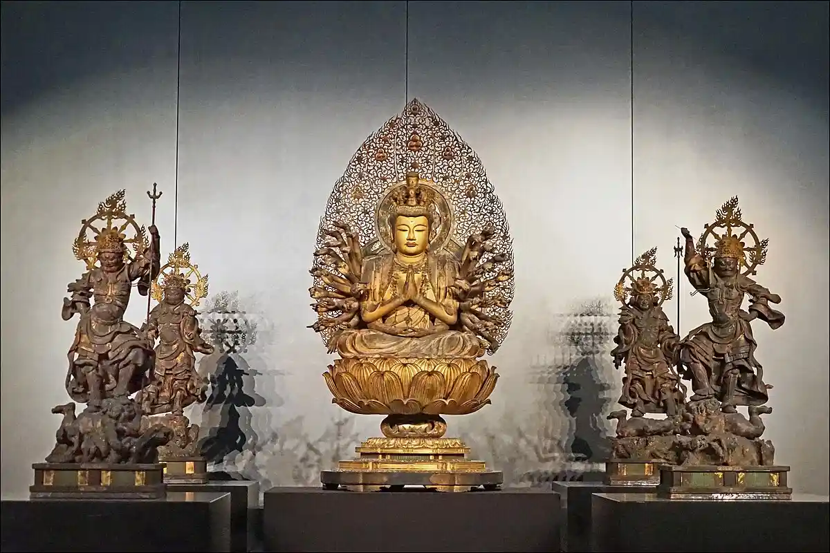 Statue of Kannon, the Bodhisattva of Compassion, depicted with a serene expression and flowing robes.

