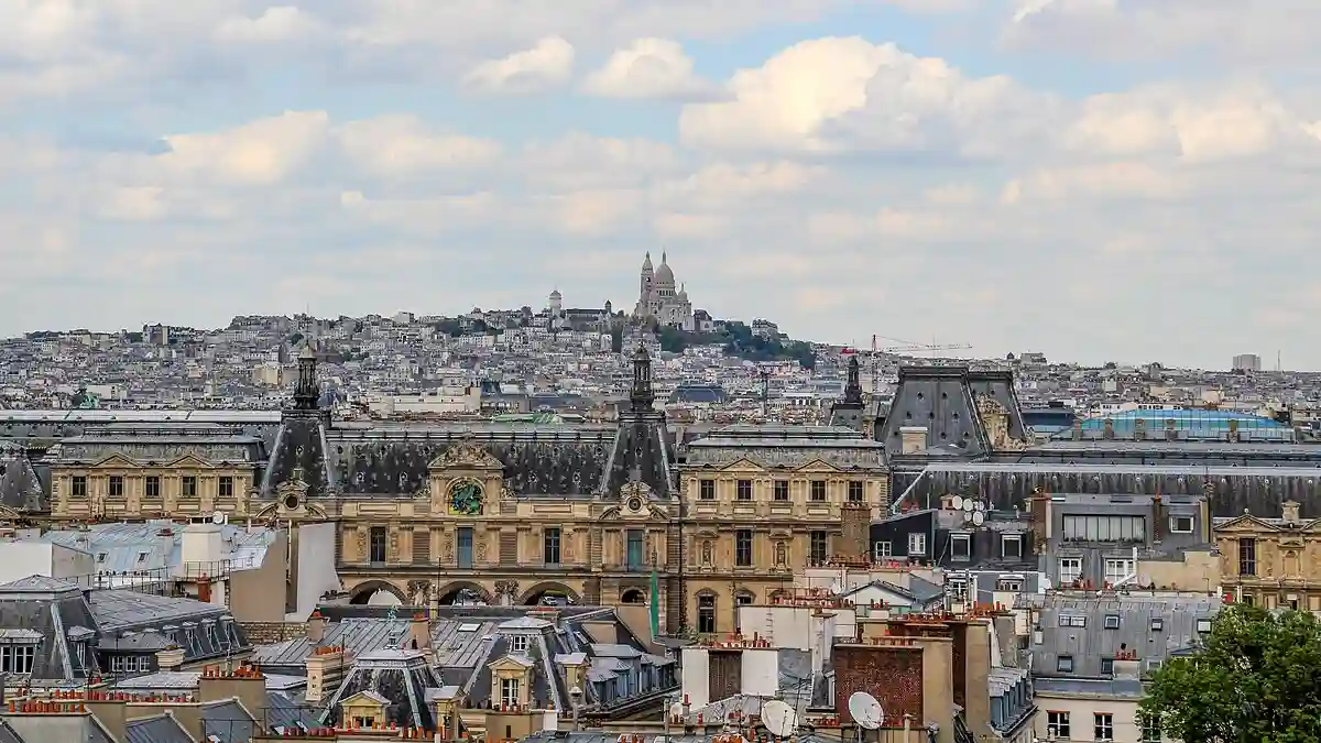 Panoramic view of Parisian rooftops from the roof of the Faculté de Médecine, with the skyline stretching towards iconic landmarks like the Eiffel Tower. Panoramic view of Parisian rooftops from the roof of the Faculté de Médecine, with the skyline stretching towards iconic landmarks like the Eiffel Tower.