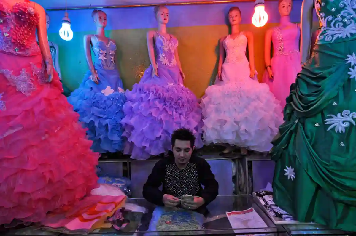 A variety of traditional Afghan wedding dresses displayed in a shop, showcasing intricate embroidery, vibrant colors, and cultural craftsmanship. A variety of traditional Afghan wedding dresses displayed in a shop, showcasing intricate embroidery, vibrant colors, and cultural craftsmanship.