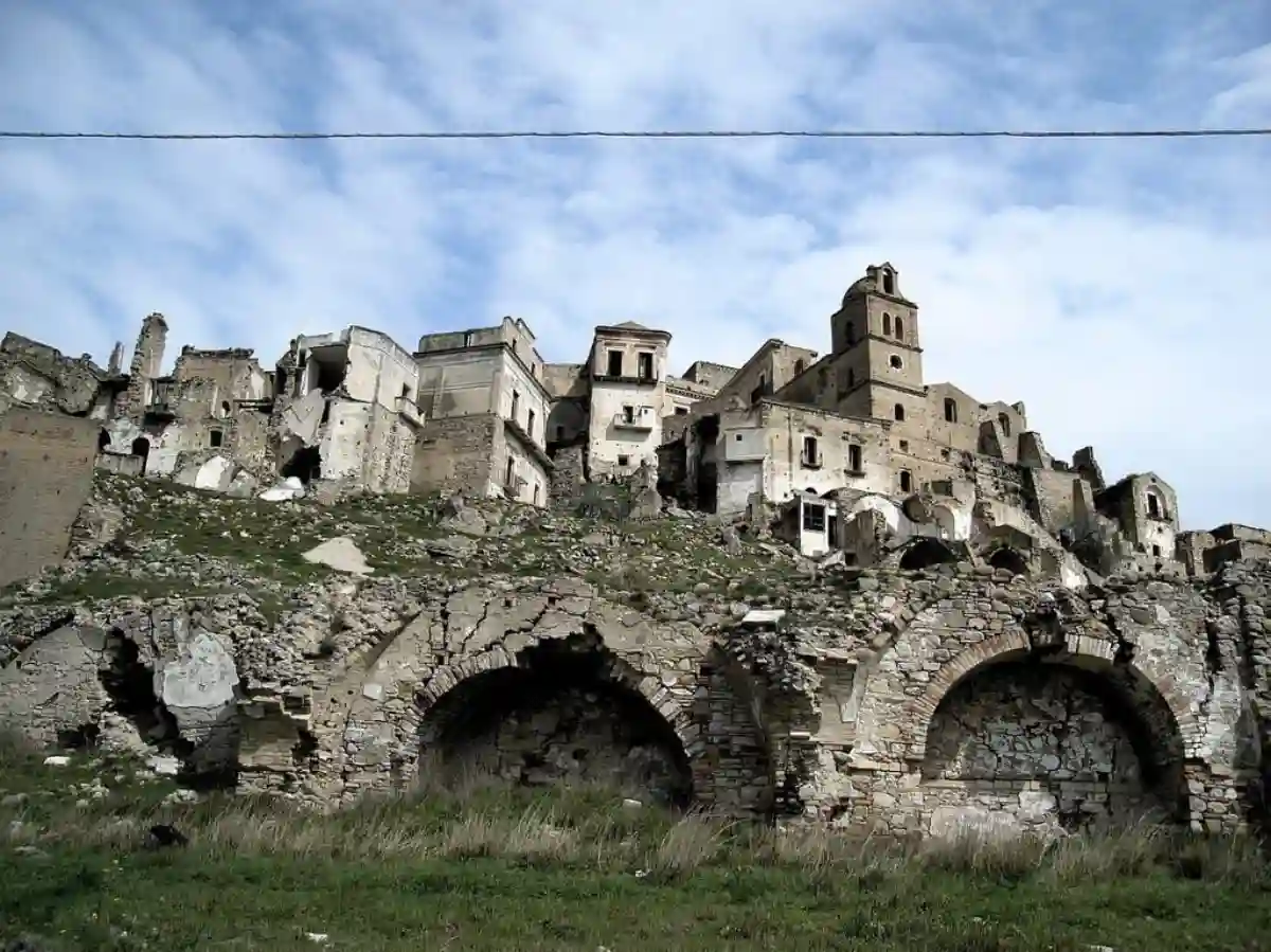 An old stone building with a tower on top of it. Craco italy homeless. An old stone building with a tower on top of it. Craco italy homeless.