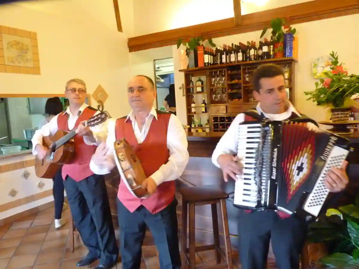 A lively entertainment performance at Sicily Restaurant, featuring traditional Italian music and dance, adding to the dining experience. A lively entertainment performance at Sicily Restaurant, featuring traditional Italian music and dance, adding to the dining experience.