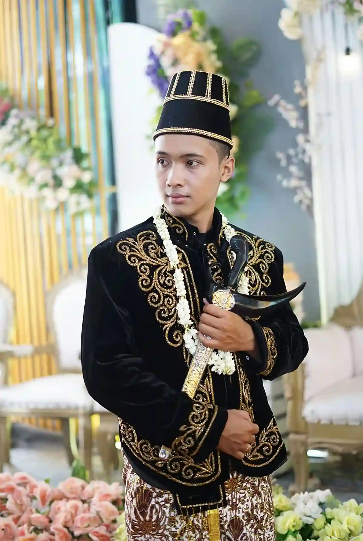 Traditional Indonesian groom's outfit, featuring a songket sarong, a batik tunic, and an ornate headpiece, embodying the beauty and cultural depth of Indonesian weddings. Traditional Indonesian groom's outfit, featuring a songket sarong, a batik tunic, and an ornate headpiece, embodying the beauty and cultural depth of Indonesian weddings.