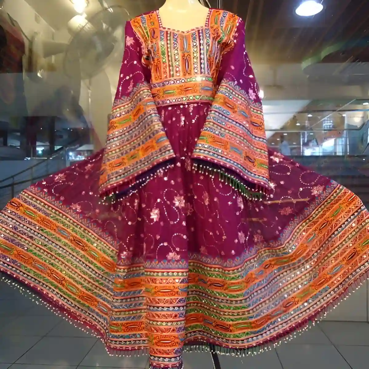 Traditional Kuchi bridal attire, adorned with colorful beads, shimmering mirrors, and elaborate embroidery, reflecting the Kuchi tribe’s rich cultural identity. Traditional Kuchi bridal attire, adorned with colorful beads, shimmering mirrors, and elaborate embroidery, reflecting the Kuchi tribe’s rich cultural identity.