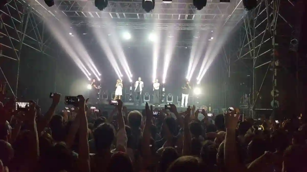 Pentatonix performing live in Rome, Italy, showcasing their signature a cappella harmonies, with an enthusiastic audience cheering. Pentatonix performing live in Rome, Italy, showcasing their signature a cappella harmonies, with an enthusiastic audience cheering.
