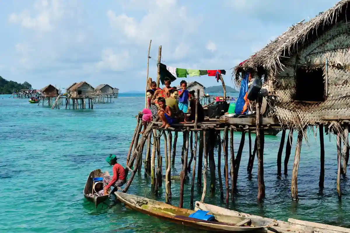A Sama-Bajau tribe village built on stilts over the ocean, with vibrant boats and homes reflecting the community’s deep connection to the sea. A Sama-Bajau tribe village built on stilts over the ocean, with vibrant boats and homes reflecting the community’s deep connection to the sea.