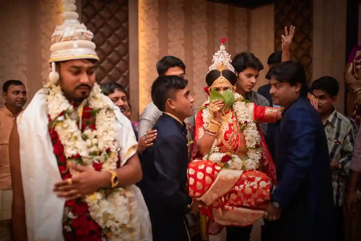 The bride and groom exchange their first gaze during the Subho Drishti ceremony, a significant moment in the Bengali wedding. The bride and groom exchange their first gaze during the Subho Drishti ceremony, a significant moment in the Bengali wedding.