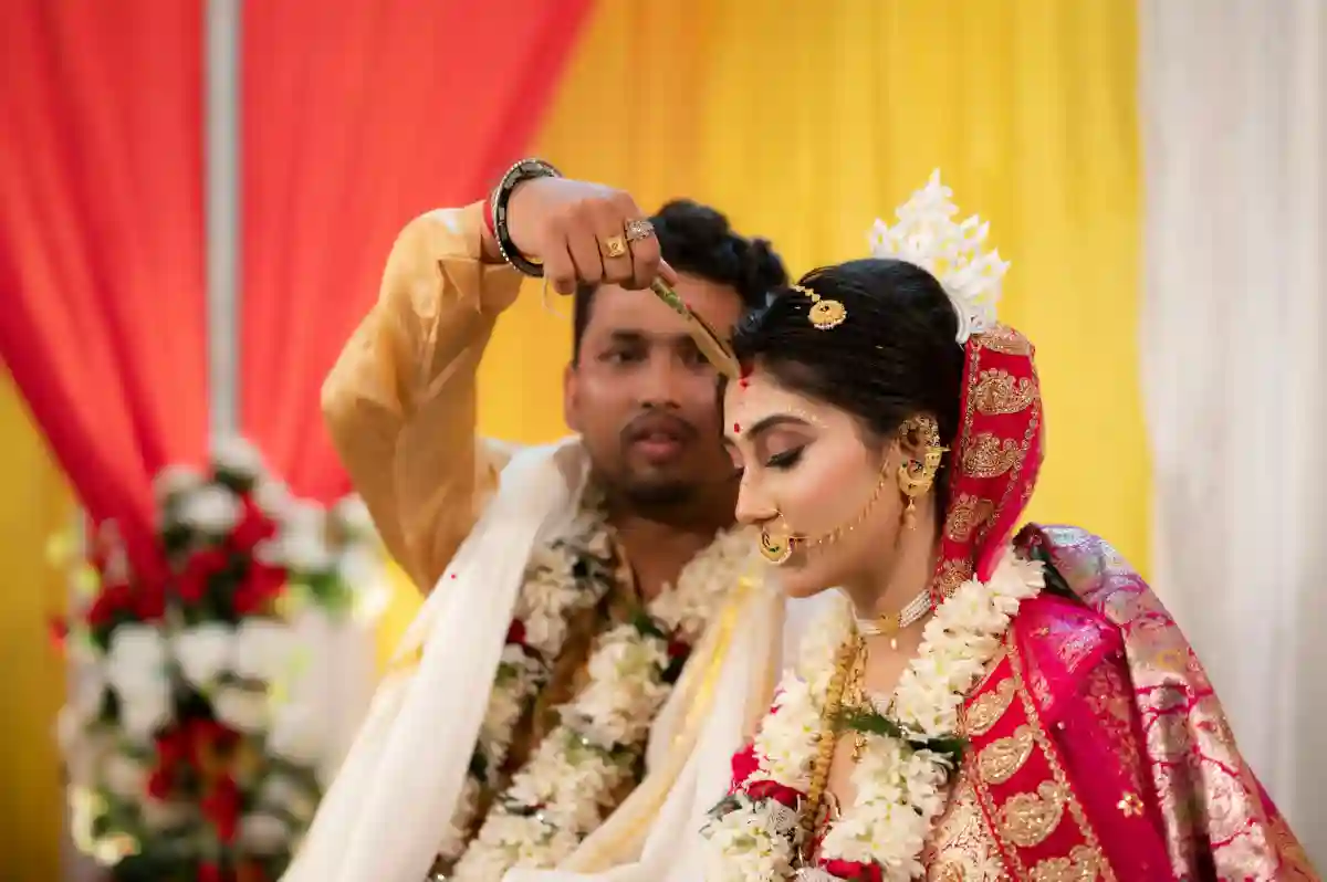 The bride and groom performing sacred rituals during a traditional Indian wedding ceremony. The bride and groom performing sacred rituals during a traditional Indian wedding ceremony.