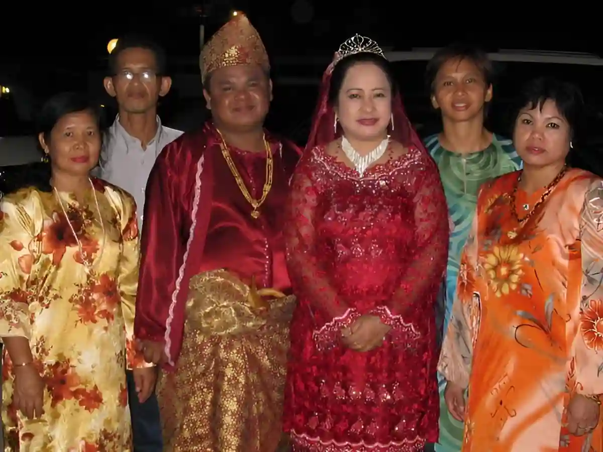 A Bajau bride and groom dressed in traditional wedding attire, showcasing vibrant fabrics, intricate embroidery, and ornamental jewelry. A Bajau bride and groom dressed in traditional wedding attire, showcasing vibrant fabrics, intricate embroidery, and ornamental jewelry.