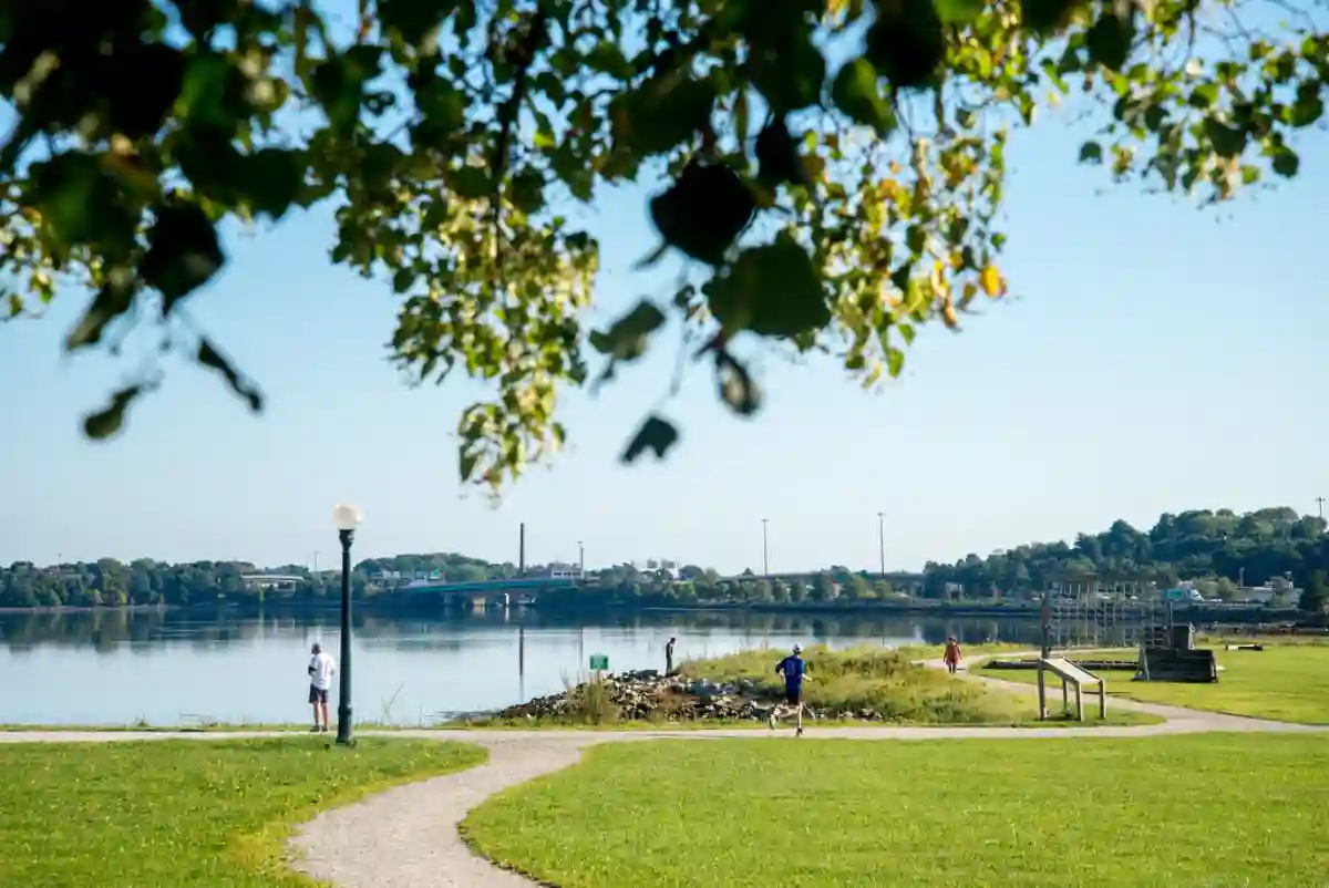 Hikers and bikers enjoying the peaceful Back Cove Trail with views of the cove and Portland skyline. Hikers and bikers enjoying the peaceful Back Cove Trail with views of the cove and Portland skyline.