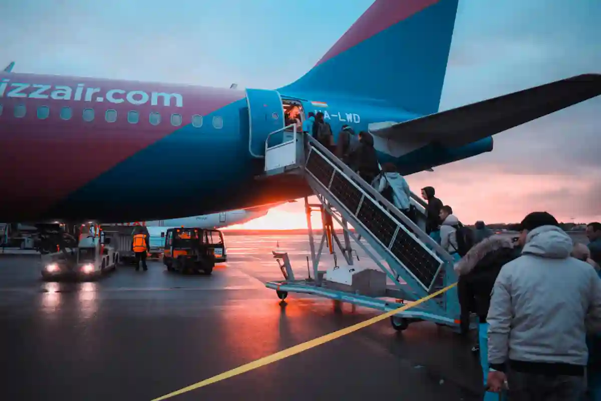 First-time flyers boarding the plane, showing travelers walking through the gate and onto the aircraft. First-time flyers boarding the plane, showing travelers walking through the gate and onto the aircraft.