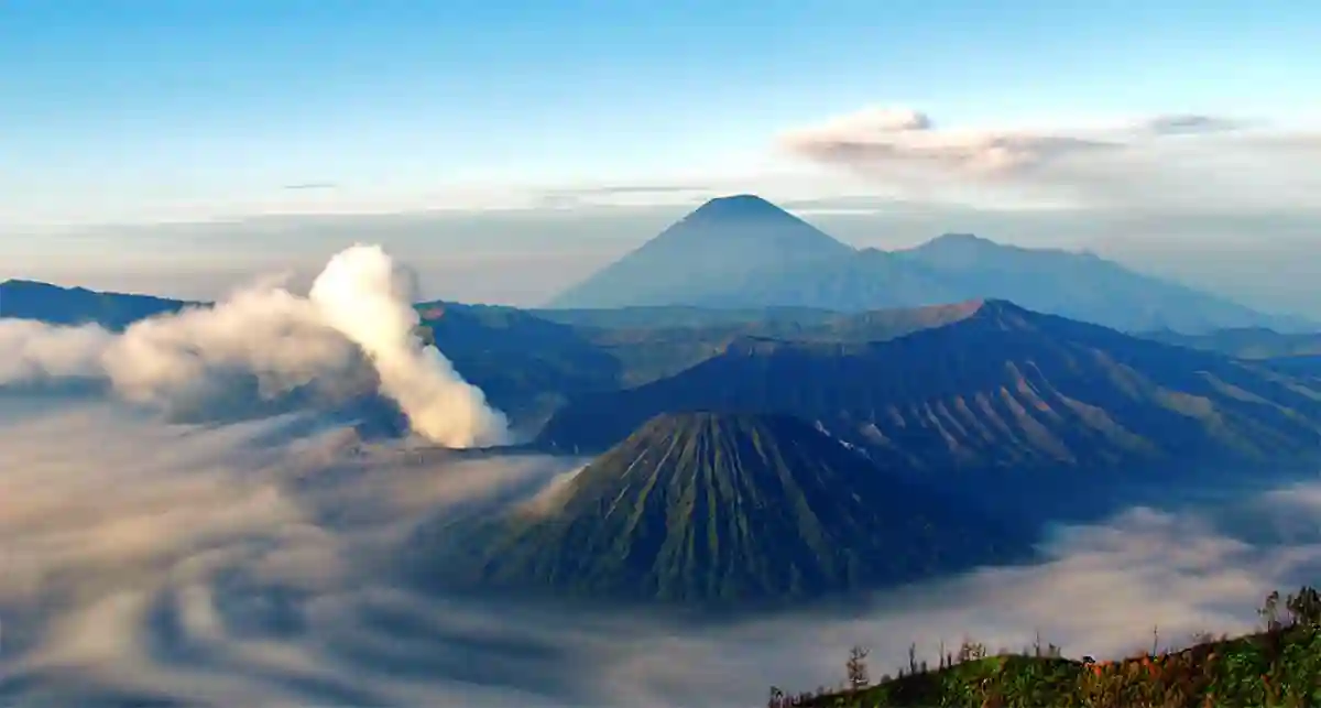 Stunning view of Mount Bromo’s active volcano with its smoke rising, surrounded by the vast Sea of Sand in East Java, Indonesia. Stunning view of Mount Bromo’s active volcano with its smoke rising, surrounded by the vast Sea of Sand in East Java, Indonesia.
