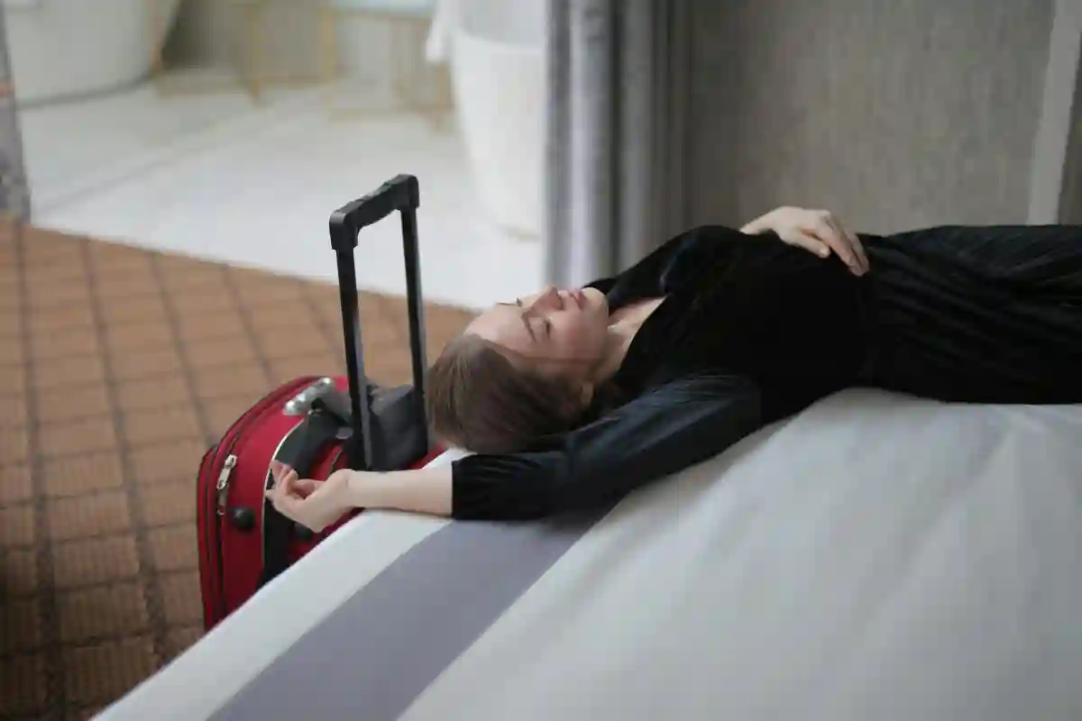 First-time flyer feeling the effects of jet lag, relaxing with a pillow and blanket on a long flight or at the airport. First-time flyer feeling the effects of jet lag, relaxing with a pillow and blanket on a long flight or at the airport.