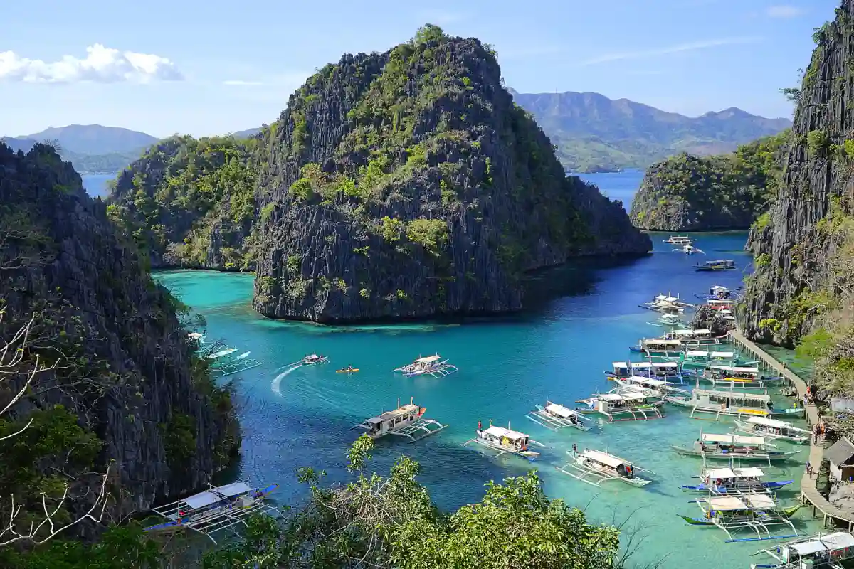 Crystal-clear waters of Kayangan Lake, Coron, Palawan, surrounded by limestone cliffs and lush greenery. Crystal-clear waters of Kayangan Lake, Coron, Palawan, surrounded by limestone cliffs and lush greenery.