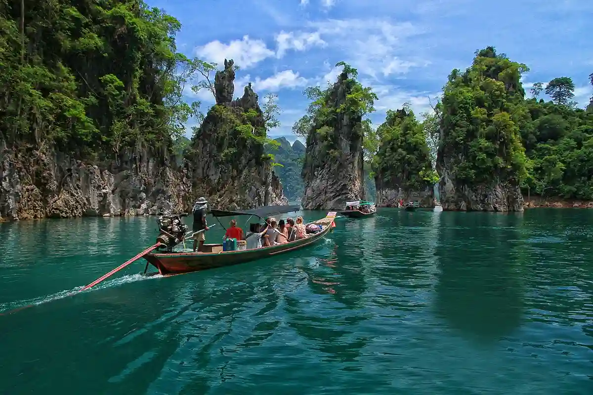 Lush greenery and towering limestone cliffs in Khao Sok National Park, Thailand – a top destination for nature lovers in Southeast Asia. Lush greenery and towering limestone cliffs in Khao Sok National Park, Thailand – a top destination for nature lovers in Southeast Asia.