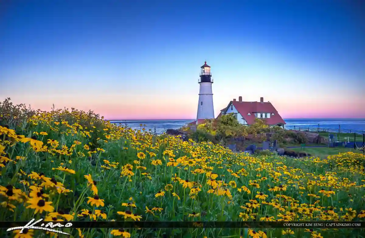 A stunning sunset over Cape Elizabeth, with warm hues painting the sky and Portland Head Light silhouetted against the colorful backdrop. A stunning sunset over Cape Elizabeth, with warm hues painting the sky and Portland Head Light silhouetted against the colorful backdrop.