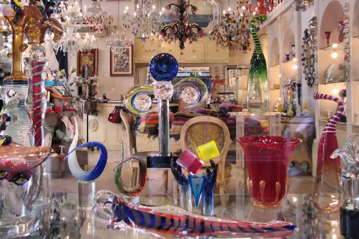 Colorful Murano glass art displayed in a shop window in Venice, showcasing intricate handmade pieces like vases and jewelry. Colorful Murano glass art displayed in a shop window in Venice, showcasing intricate handmade pieces like vases and jewelry.