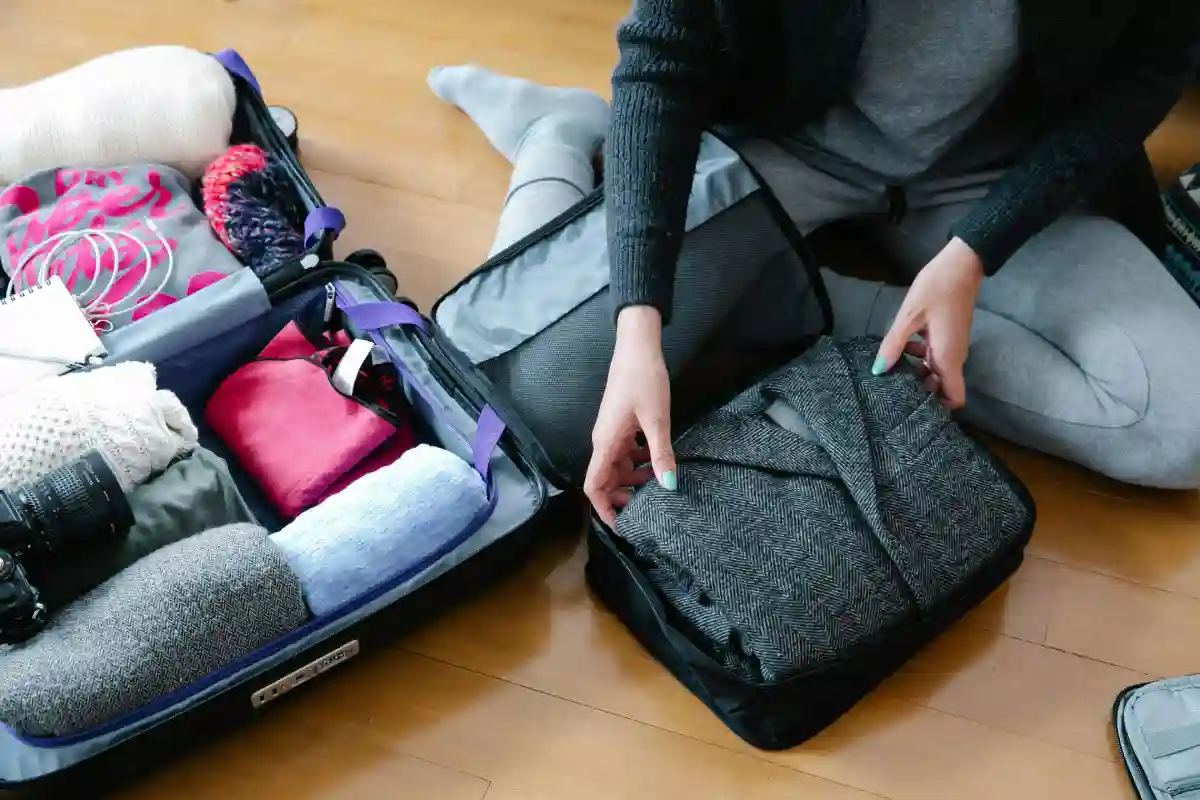 A set of packing cubes neatly organized inside a suitcase, helping to maximize space and keep clothes tidy. A set of packing cubes neatly organized inside a suitcase, helping to maximize space and keep clothes tidy.