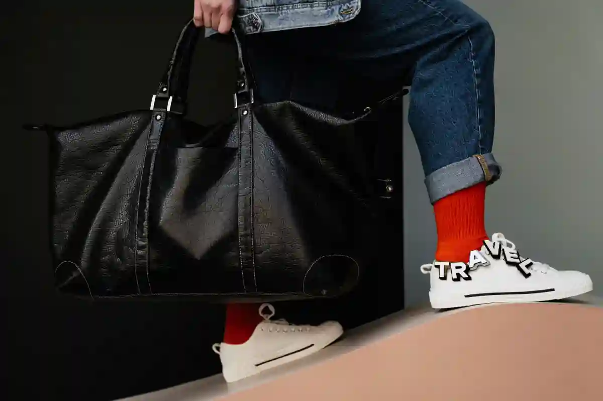 person carrying a stylish duffel bag, walking confidently and ready for their next adventure. person carrying a stylish duffel bag, walking confidently and ready for their next adventure.