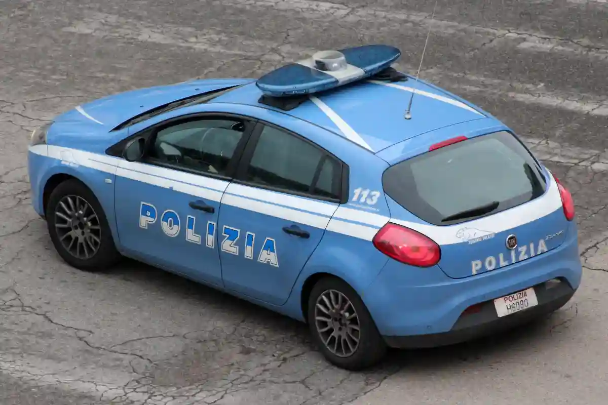 An Italian police car patrolling the streets, showcasing the distinctive blue and white colors of the law enforcement in Italy. An Italian police car patrolling the streets, showcasing the distinctive blue and white colors of the law enforcement in Italy.