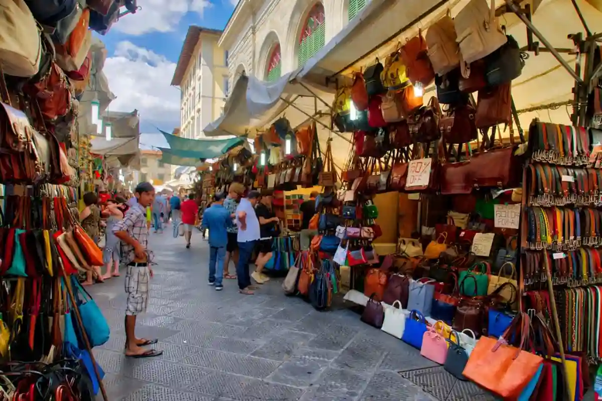 Shoppers browsing leather goods at San Lorenzo Market, one of Florence’s most iconic spots for high-quality Italian leather products. Shoppers browsing leather goods at San Lorenzo Market, one of Florence’s most iconic spots for high-quality Italian leather products.
