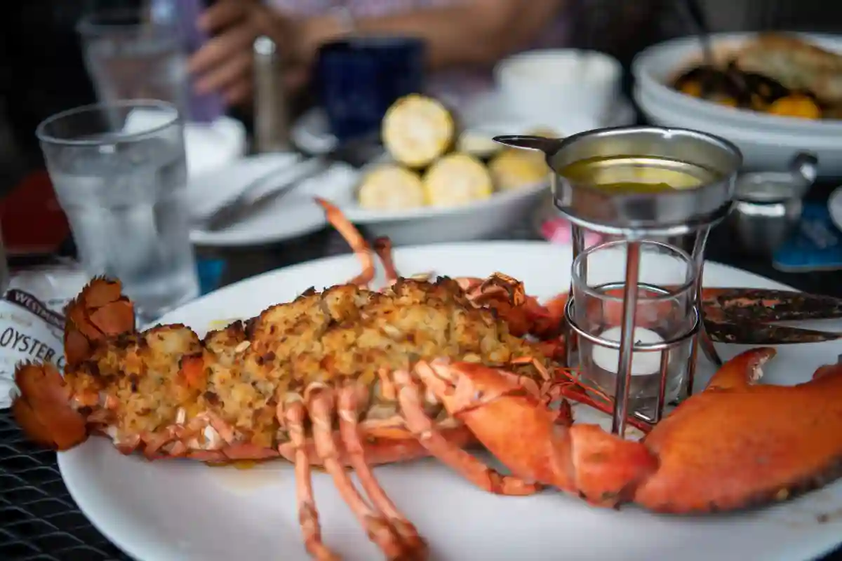 A plate of freshly prepared lobster and seafood served with melted butter and lemon, a Portland culinary specialty.Portland, Maine, is renowned for its exceptional seafood, especially its famous lobsters. A plate of freshly prepared lobster and seafood served with melted butter and lemon, a Portland culinary specialty.Portland, Maine, is renowned for its exceptional seafood, especially its famous lobsters.