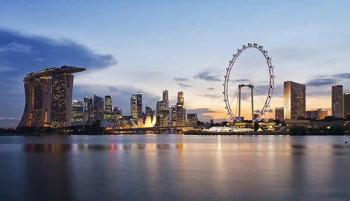 Stunning sunset view of Singapore's skyline from Gardens by the Bay East, showcasing modern skyscrapers. Stunning sunset view of Singapore's skyline from Gardens by the Bay East, showcasing modern skyscrapers.
