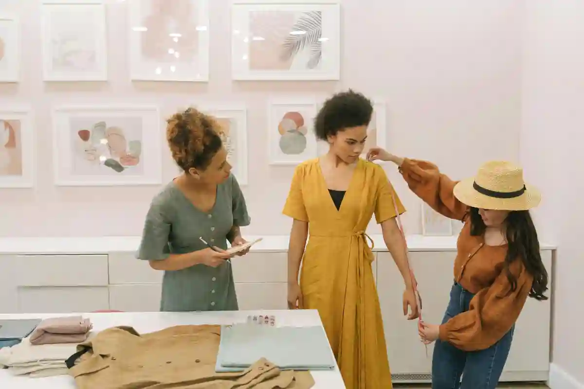 Woman Wearing a Hat Measuring a Woman's Arm Woman Wearing a Hat Measuring a Woman's Arm