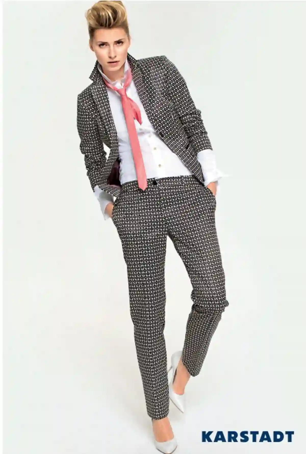 A tomboy model standing tall in a casual outfit, wearing tailored pants, a fitted jacket, and sneakers, radiating confidence and effortless style. A tomboy model standing tall in a casual outfit, wearing tailored pants, a fitted jacket, and sneakers, radiating confidence and effortless style.