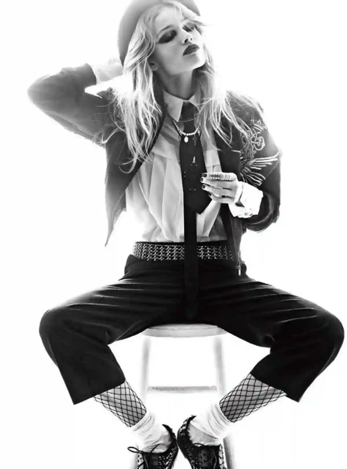A black-and-white image of a tomboy sitting on a chair, dressed in casual, comfortable clothing such as a loose shirt and trousers, showcasing a relaxed yet confident attitude. A black-and-white image of a tomboy sitting on a chair, dressed in casual, comfortable clothing such as a loose shirt and trousers, showcasing a relaxed yet confident attitude.