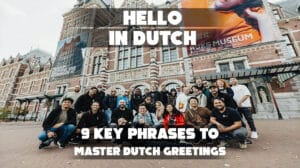 A cheerful group of people standing in front of a famous landmark in the Netherlands, smiling and enjoying their time together. - Hello in Dutch